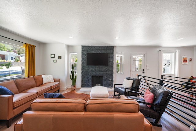 2500 E Simpson Ave S, Salt Lake City, UT 84109 - living area featuring plenty of natural light, light wood finished floors, a fireplace, a textured ceiling, and recessed lighting