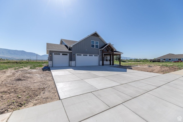 2864 N 3475 W, Plain City, UT 84404 - craftsman house with board and batten siding, a mountain view, concrete driveway, and an attached garage