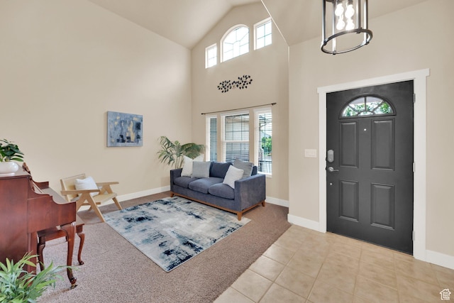 356 Warley Way, Stansbury Park, UT 84074 - carpeted foyer entrance with tile patterned floors, a chandelier, and high vaulted ceiling