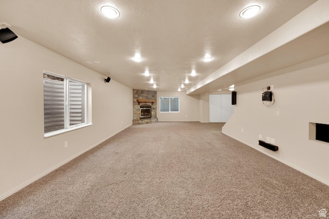 356 Warley Way, Stansbury Park, UT 84074 - unfurnished living room with carpet and a stone fireplace