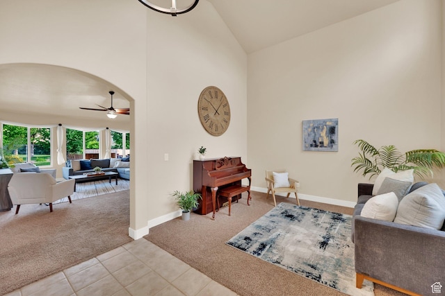 356 Warley Way, Stansbury Park, UT 84074 - carpeted living room with a ceiling fan, high vaulted ceiling, tile patterned floors, and arched walkways