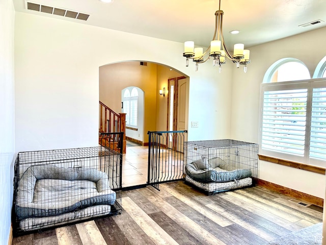 620 S Michael St, Vernal, UT 84078 - living area featuring arched walkways, wood finished floors, a chandelier, and recessed lighting