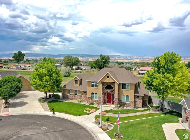 620 S Michael St, Vernal, UT 84078 - view of front of home with stone siding, a mountain view, a shingled roof, and stucco siding