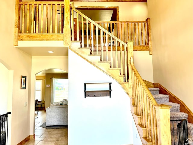 620 S Michael St, Vernal, UT 84078 - stairs with arched walkways, tile patterned floors, and a high ceiling