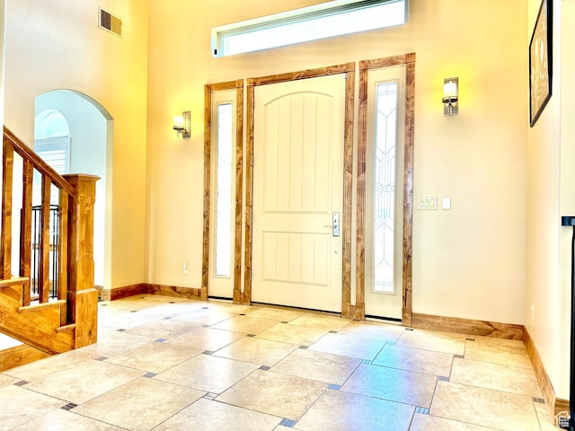 620 S Michael St, Vernal, UT 84078 - entryway featuring plenty of natural light, arched walkways, stairs, and a high ceiling