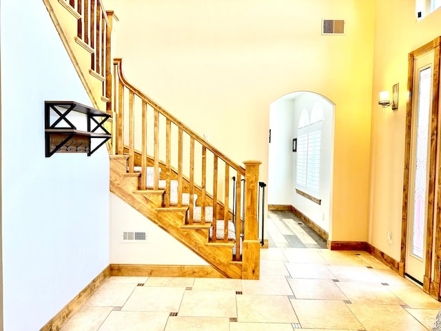 620 S Michael St, Vernal, UT 84078 - entryway featuring arched walkways, a high ceiling, and stairs