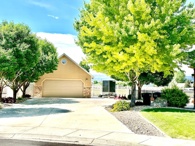 620 S Michael St, Vernal, UT 84078 - view of property hidden behind natural elements with driveway, a garage, and stucco siding