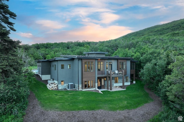 8960 Parleys Ln, Park City, UT 84098 - rear view of house with a yard, a wooded view, stucco siding, and a deck