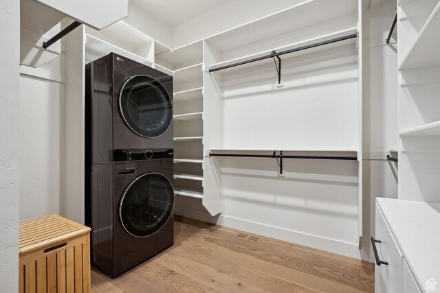 8960 Parleys Ln, Park City, UT 84098 - laundry area with stacked washer and clothes dryer and light wood-style floors