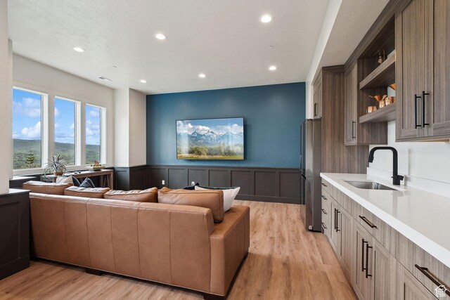 8960 Parleys Ln, Park City, UT 84098 - living room featuring recessed lighting, light wood-style flooring, a wainscoted wall, and a decorative wall