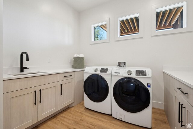 8960 Parleys Ln, Park City, UT 84098 - washroom with independent washer and dryer, light wood-style flooring, and cabinet space