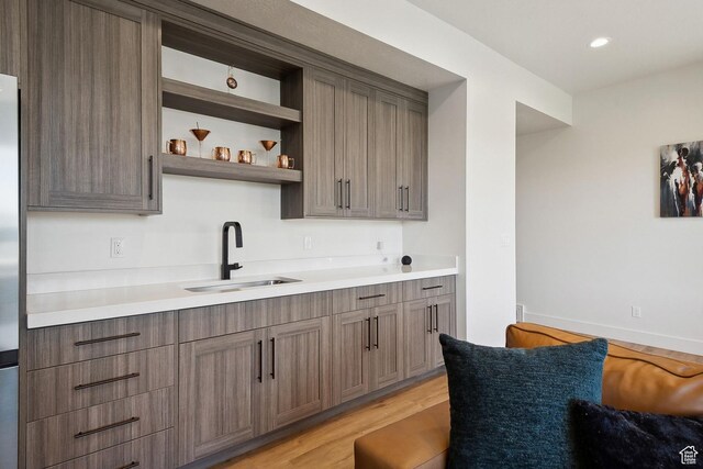 8960 Parleys Ln, Park City, UT 84098 - kitchen with light wood-type flooring, light countertops, open shelves, stainless steel fridge, and recessed lighting
