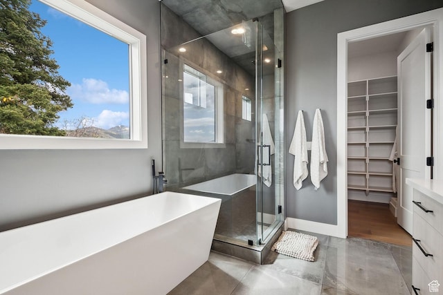 8960 Parleys Ln, Park City, UT 84098 - bathroom featuring a soaking tub, a walk in closet, and a stall shower