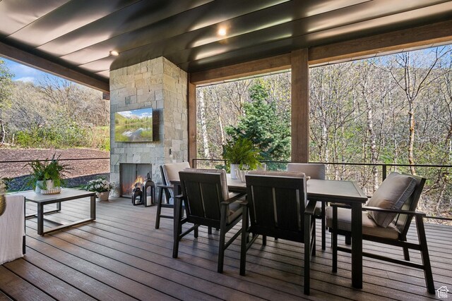 8960 Parleys Ln, Park City, UT 84098 - deck with an outdoor stone fireplace and outdoor dining area