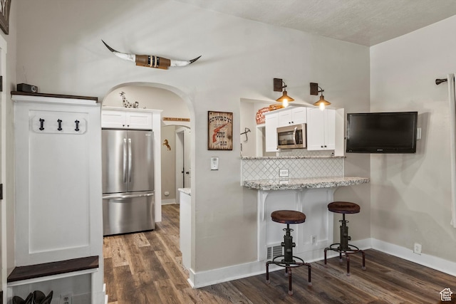 3530 Madison Ave, Ogden, UT 84403 - kitchen featuring stainless steel appliances, white cabinetry, and dark wood-style floors