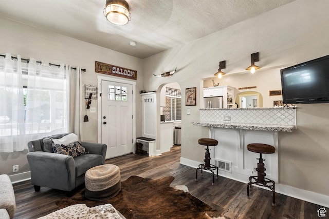 3530 Madison Ave, Ogden, UT 84403 - living area with arched walkways and dark wood finished floors