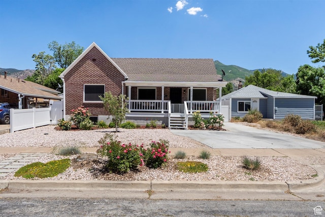 3530 Madison Ave, Ogden, UT 84403 - view of front facade featuring covered porch, brick siding, and a mountain view