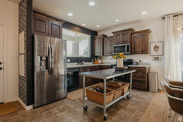 480 Firestone Dr, Santaquin, UT 84655 - kitchen featuring black appliances, dark brown cabinetry, recessed lighting, and dark stone finish flooring