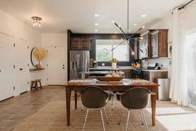 480 Firestone Dr, Santaquin, UT 84655 - kitchen with appliances with stainless steel finishes, dark brown cabinets, a chandelier, recessed lighting, and light countertops