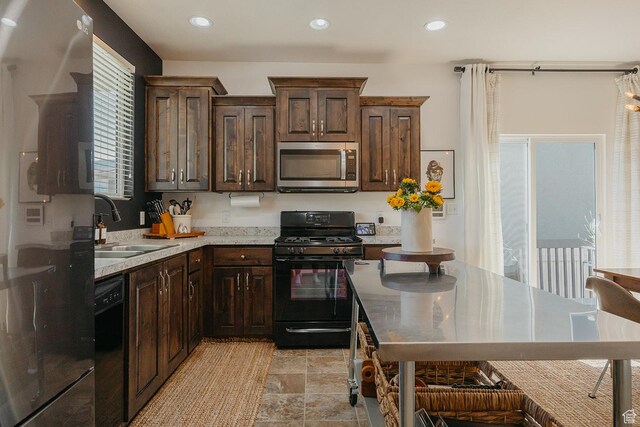480 Firestone Dr, Santaquin, UT 84655 - kitchen featuring black appliances, dark brown cabinetry, recessed lighting, and light stone finish floors