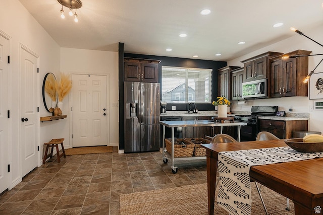 480 Firestone Dr, Santaquin, UT 84655 - kitchen featuring appliances with stainless steel finishes, dark brown cabinets, light countertops, recessed lighting, and dark stone finish flooring