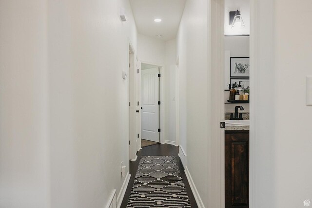480 Firestone Dr, Santaquin, UT 84655 - hallway featuring a sink and dark colored carpet
