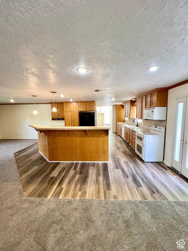 90 W 640 N, Richfield, UT 84701 - kitchen with white appliances, light countertops, brown cabinetry, carpet, and a textured ceiling