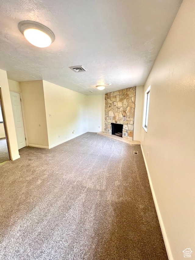 90 W 640 N, Richfield, UT 84701 - unfurnished living room with a fireplace, carpet, and a textured ceiling
