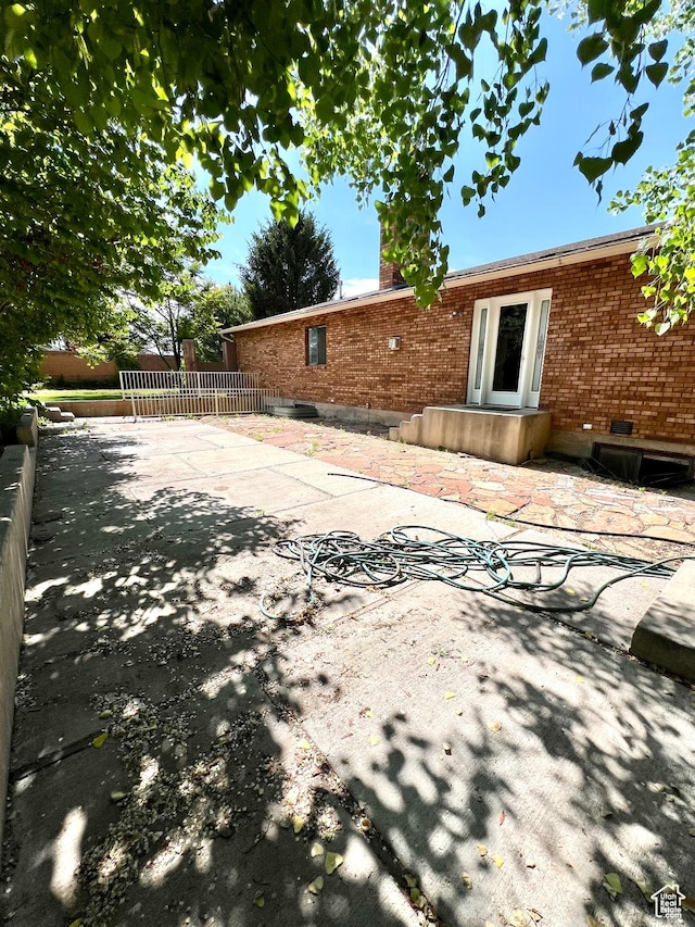 90 W 640 N, Richfield, UT 84701 - back of house featuring brick siding, a patio, and a chimney