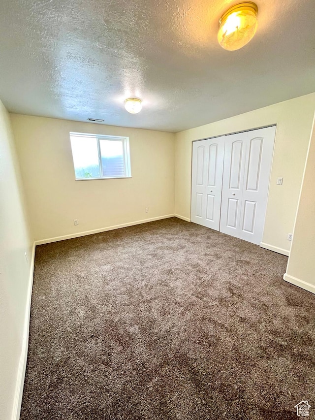 90 W 640 N, Richfield, UT 84701 - unfurnished bedroom with a textured ceiling, a closet, and carpet
