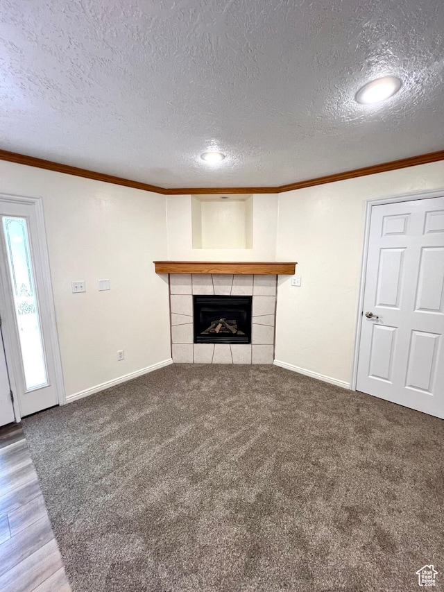 90 W 640 N, Richfield, UT 84701 - unfurnished living room with ornamental molding, a tiled fireplace, a textured ceiling, and carpet floors
