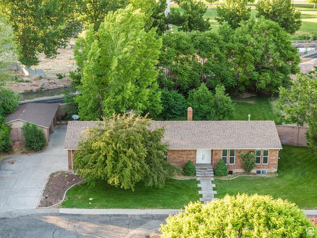 90 W 640 N, Richfield, UT 84701 - view of front of home with brick siding, a front lawn, roof with shingles, and a chimney