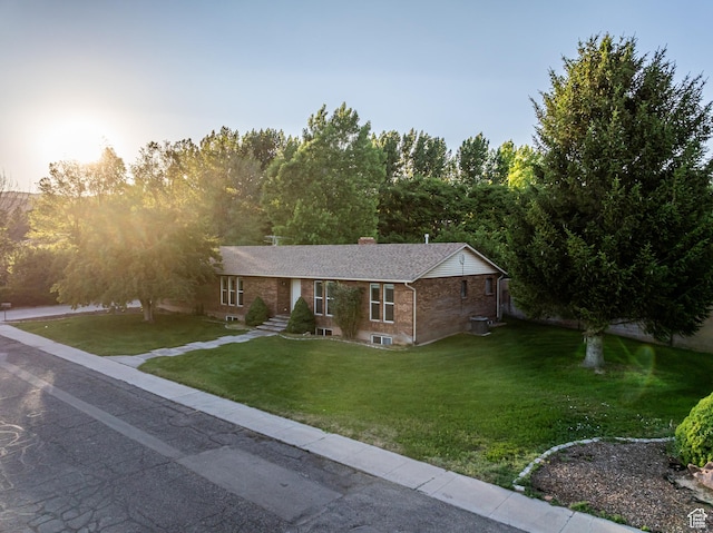 90 W 640 N, Richfield, UT 84701 - ranch-style home with brick siding, a front yard, and a chimney