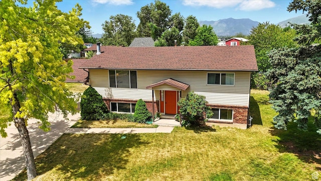 167 E 950 S, Layton, UT 84041 - split foyer home with brick siding, a front yard, a mountain view, and roof with shingles