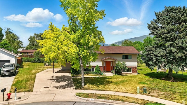 167 E 950 S, Layton, UT 84041 - bi-level home with a mountain view, brick siding, a front lawn, and concrete driveway