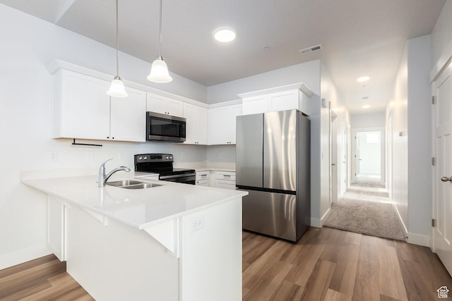 1454 N 3830 W Unit 303, Lehi, UT 84043 - kitchen with stainless steel appliances, a peninsula, light wood-style flooring, white cabinets, and light countertops