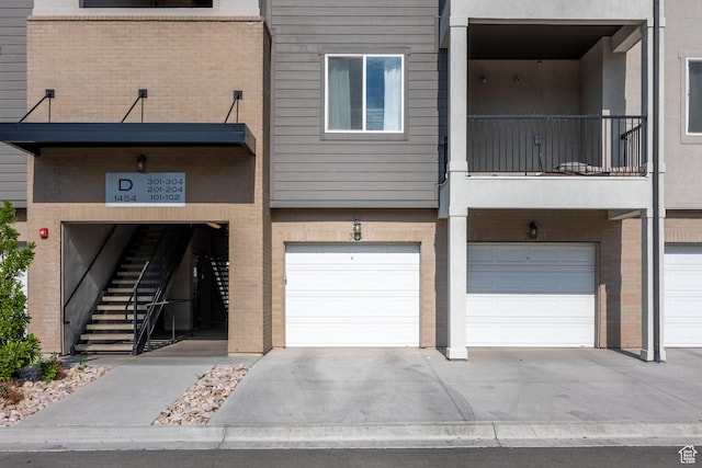 1454 N 3830 W Unit 303, Lehi, UT 84043 - view of building exterior with a garage and driveway