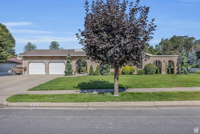 315 E Oak Ln, Kaysville, UT 84037 - view of front of property with a front yard, concrete driveway, a garage, and brick siding