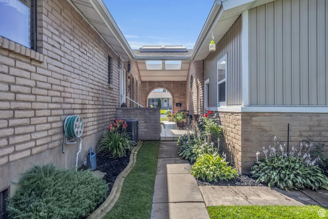 315 E Oak Ln, Kaysville, UT 84037 - doorway to property with board and batten siding, brick siding, and roof mounted solar panels