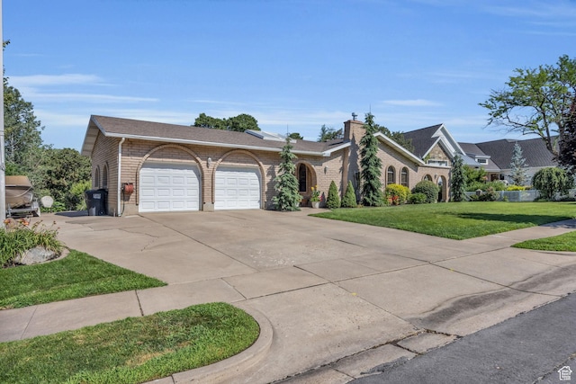 315 E Oak Ln, Kaysville, UT 84037 - view of front facade with an attached garage, concrete driveway, a front lawn, and brick siding
