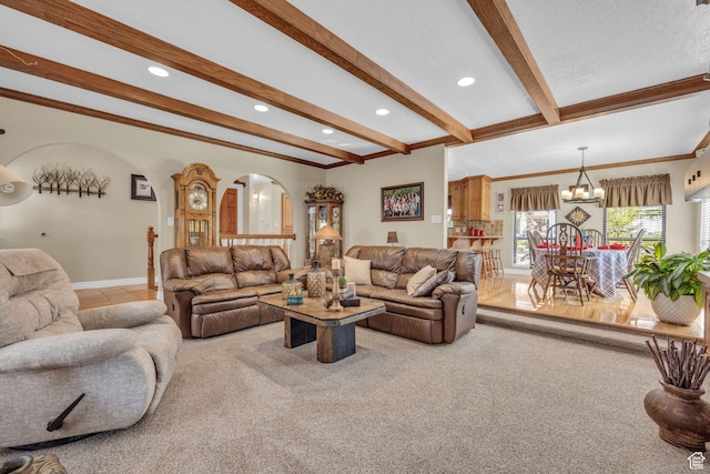315 E Oak Ln, Kaysville, UT 84037 - carpeted living area featuring arched walkways, beamed ceiling, a chandelier, recessed lighting, and crown molding