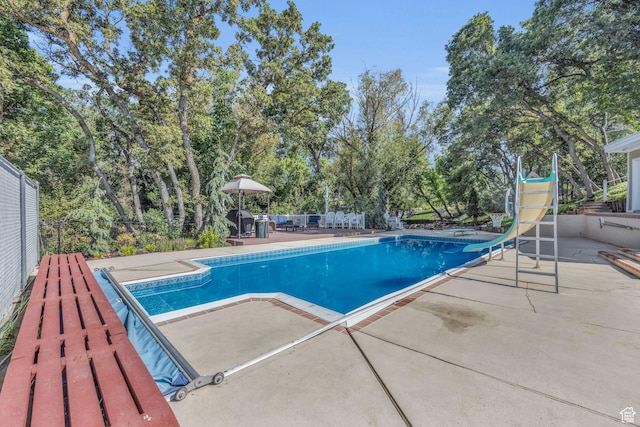 315 E Oak Ln, Kaysville, UT 84037 - outdoor pool featuring a patio, a water slide, and view of scattered trees