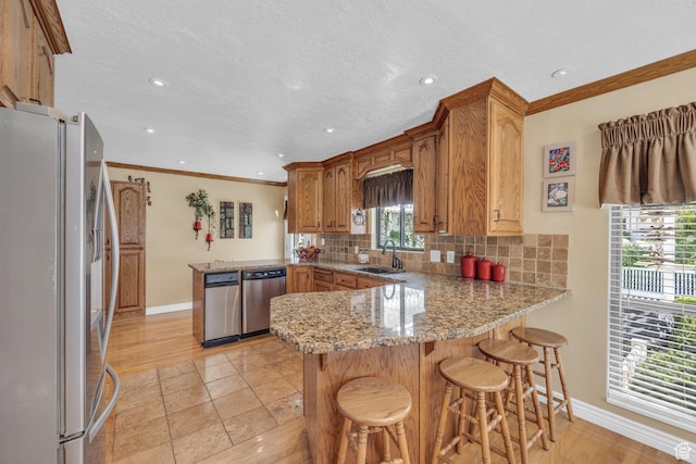 315 E Oak Ln, Kaysville, UT 84037 - kitchen featuring appliances with stainless steel finishes, a peninsula, backsplash, recessed lighting, and light stone counters