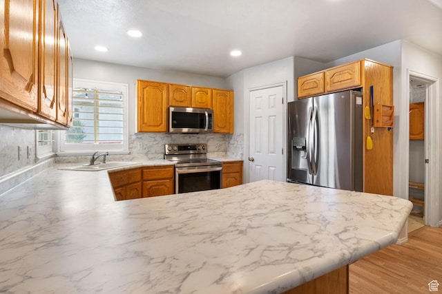9353 S 4460 W, West Jordan, UT 84088 - kitchen with stainless steel appliances, a peninsula, light countertops, decorative backsplash, and recessed lighting