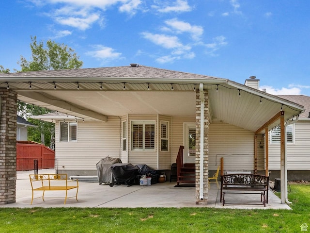 9353 S 4460 W, West Jordan, UT 84088 - back of house with entry steps, a chimney, a patio area, and a shingled roof