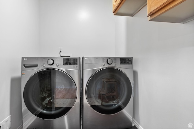 9353 S 4460 W, West Jordan, UT 84088 - laundry area featuring cabinet space and separate washer and dryer