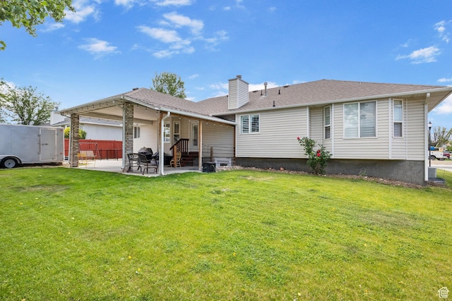 9353 S 4460 W, West Jordan, UT 84088 - rear view of property with a patio area, a chimney, and a lawn