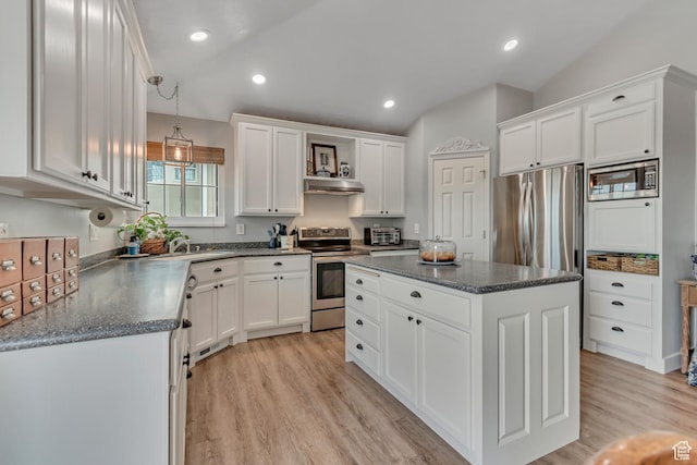 5718 W Silver Rose Cir S, Herriman, UT 84096 - kitchen featuring appliances with stainless steel finishes, under cabinet range hood, white cabinets, a kitchen island, and light wood-type flooring