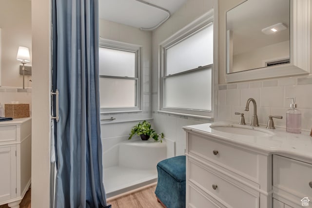 5718 W Silver Rose Cir S, Herriman, UT 84096 - bathroom featuring vanity, wood finished floors, a shower with shower curtain, and decorative backsplash