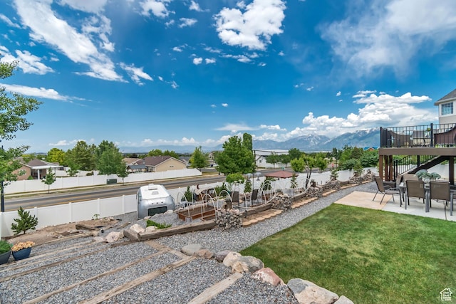5718 W Silver Rose Cir S, Herriman, UT 84096 - fenced backyard with a patio area, a residential view, and a deck with mountain view